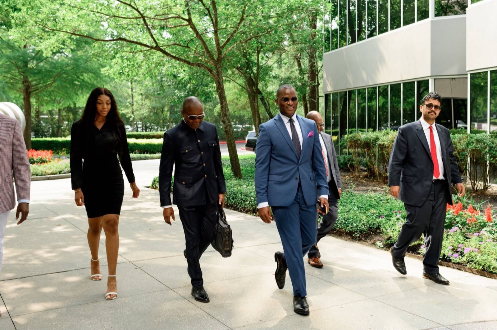 The Kachikwu & Nama team walking outside the firm's office building in The Woodlands, Texas